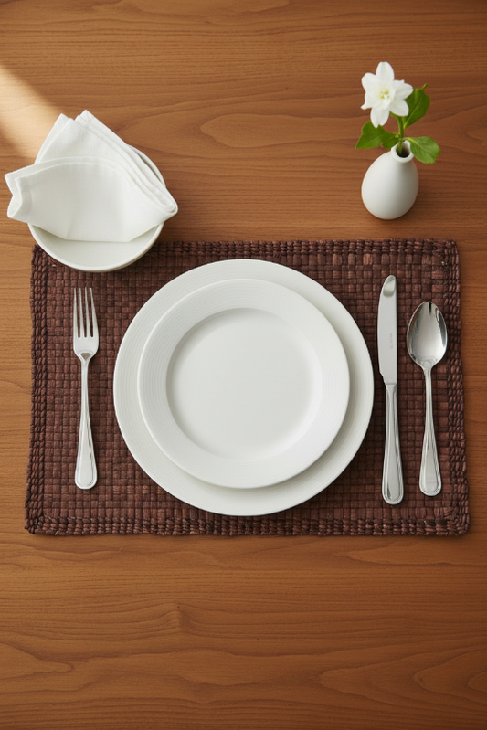 A rectangular, brown water hyacinth placemat with a textured surface, displayed on a marble background.
